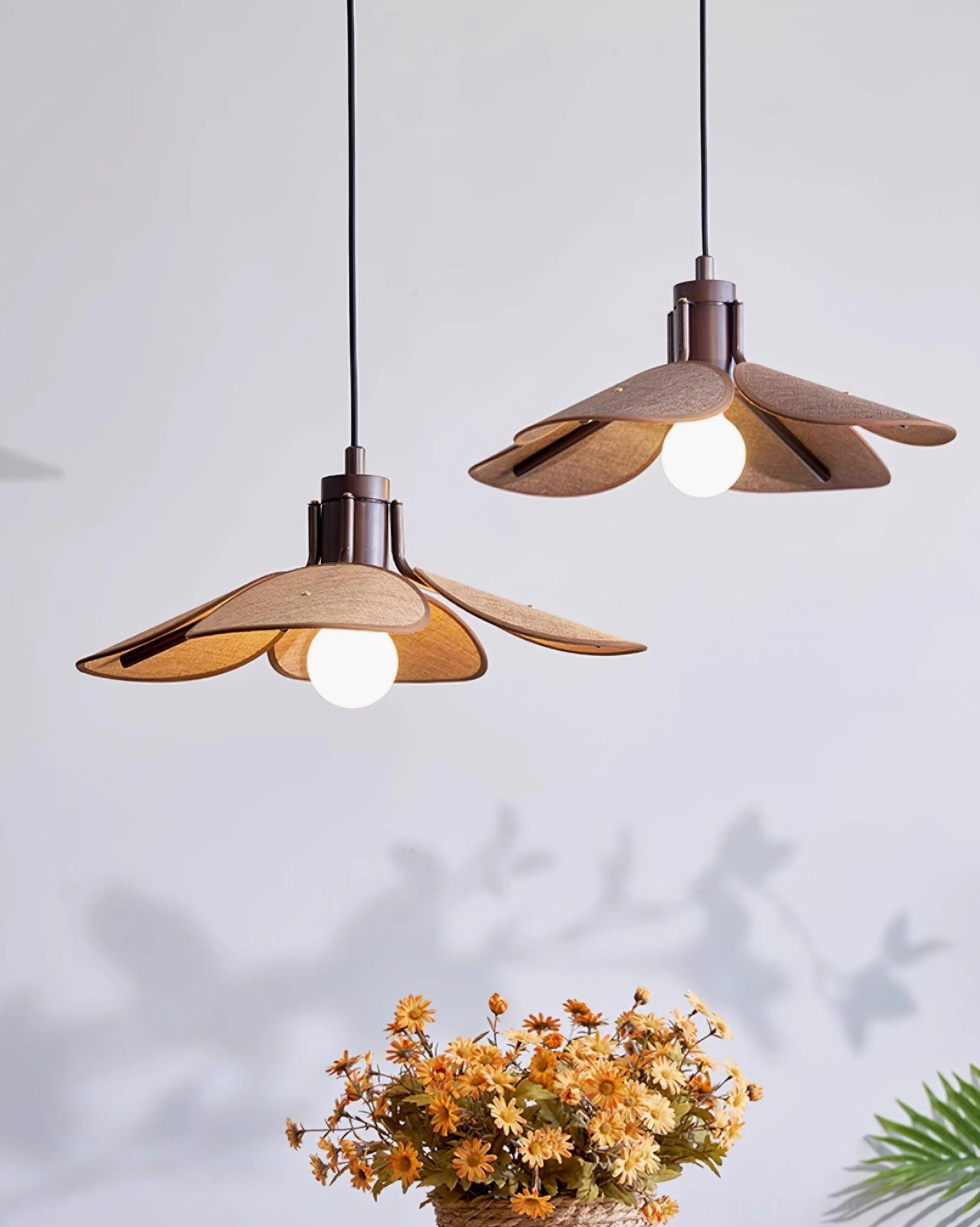 Hand-woven rattan flower pendant creating diffused warm lighting in contemporary dining room