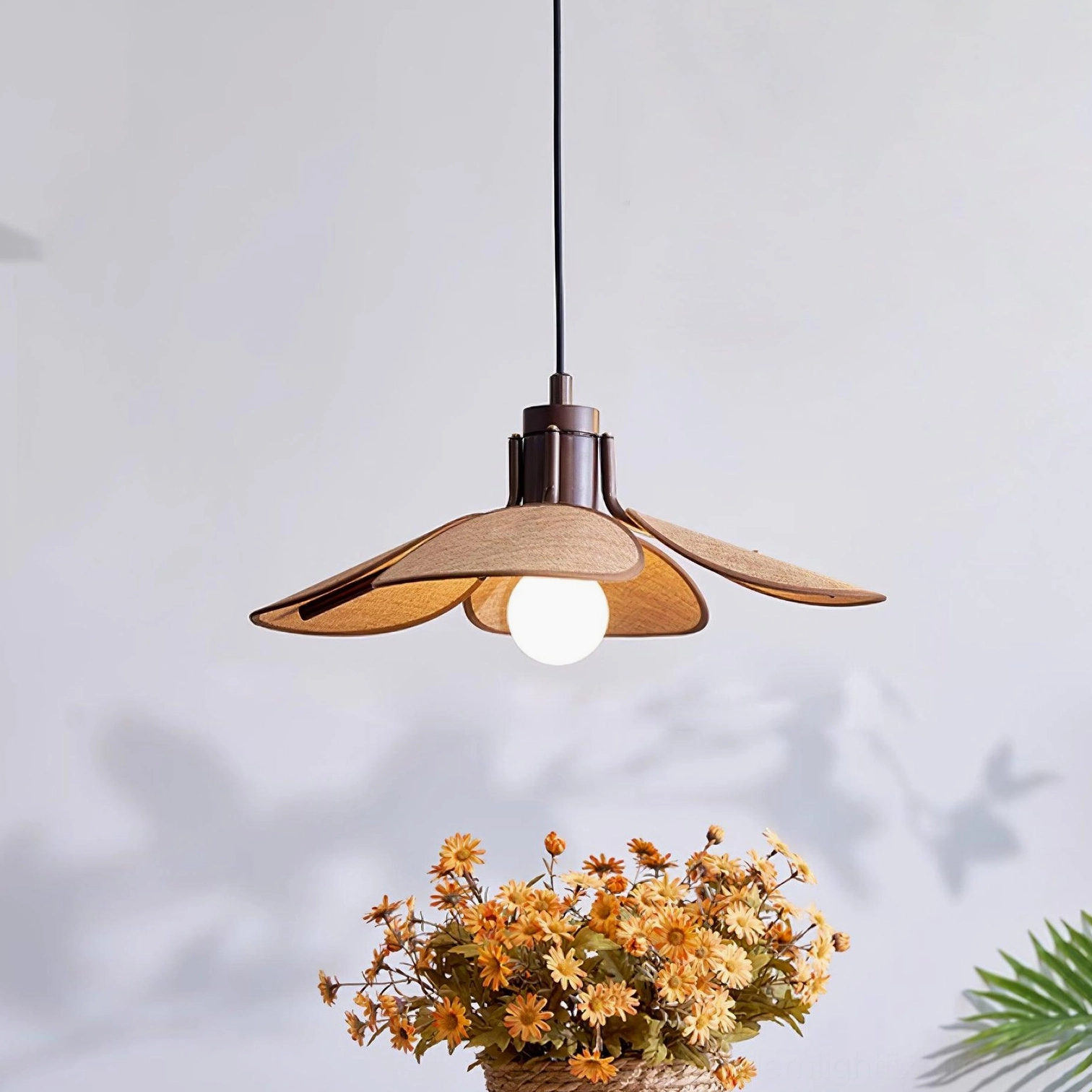 Hand-woven rattan pendant light in light brown finish with dark brown hardware and fabric shade