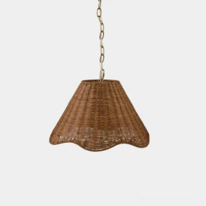 Hand-woven rattan pendant light with scalloped wavy hem and gold chain suspension on white studio background
