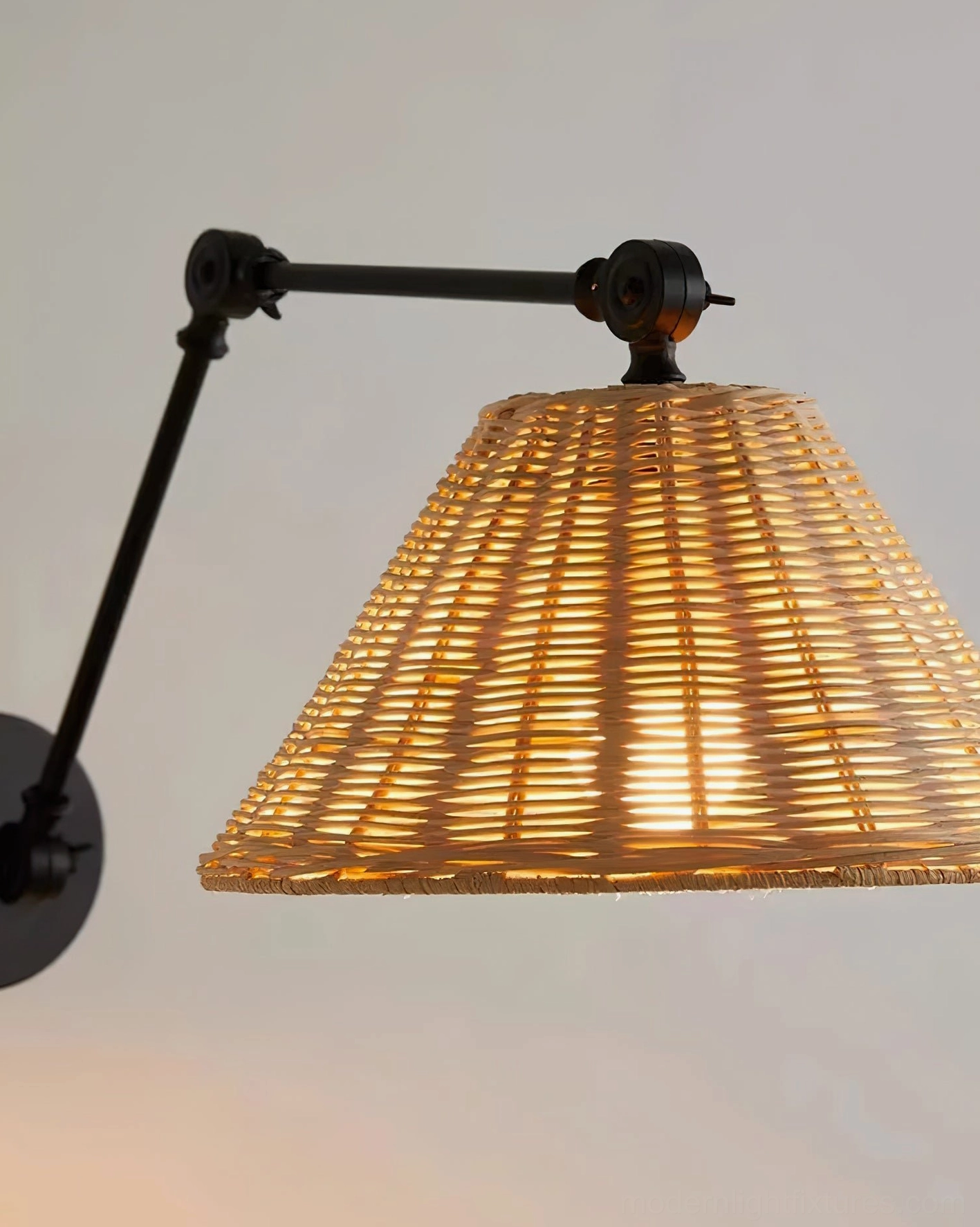 Hand-woven natural rattan shade on swing arm wall sconce - detail and material quality showcase