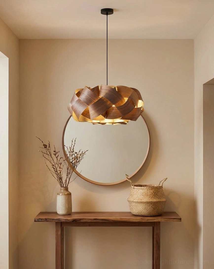 Artisan hand-woven walnut pendant light in modern entryway with wooden console and round mirror decor