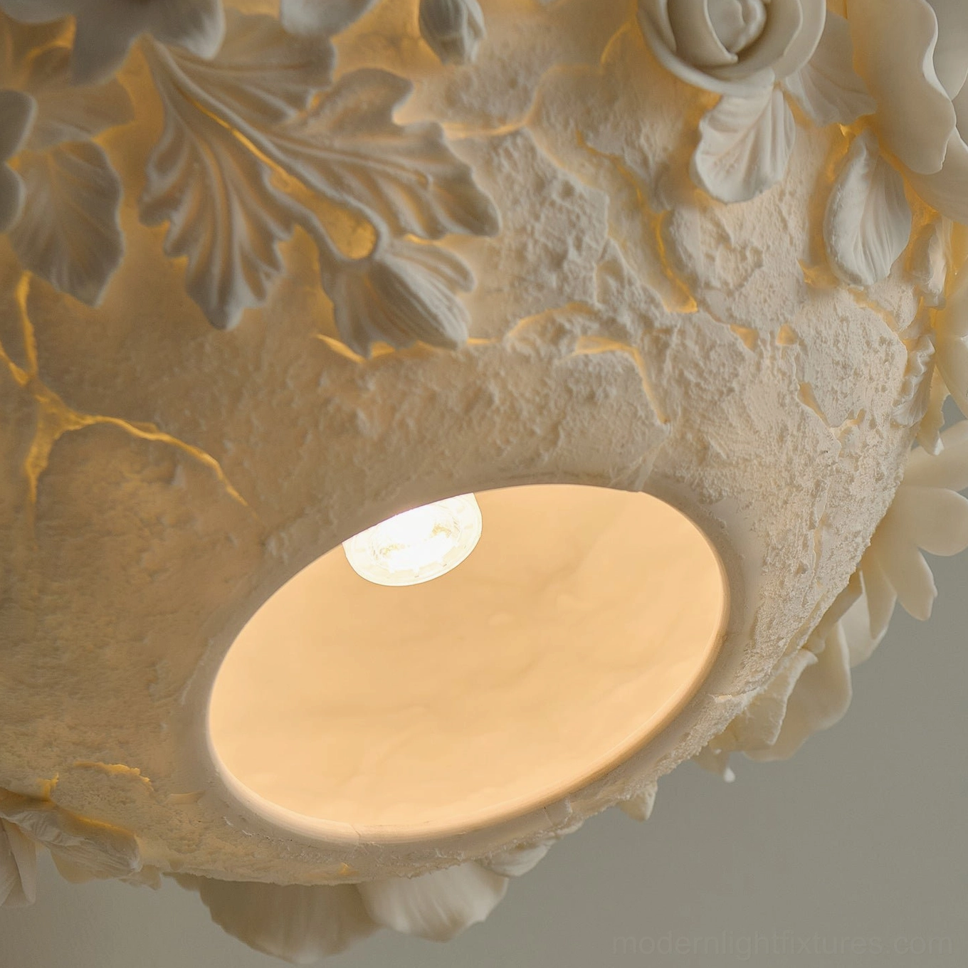 Handcrafted ceramic floral pendant light with dimensional sculptural design, warm ambient illumination in home setting