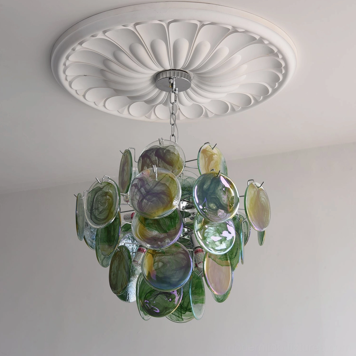 Detailed view of handcrafted iridescent glass discs on modern chandelier showing unique textures