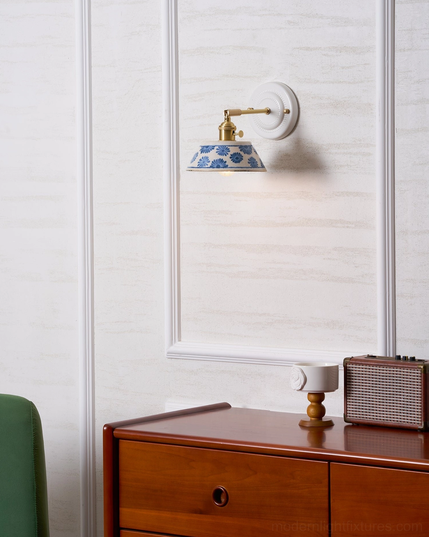 Handcrafted indigo porcelain wall lamp creating warm glow in home interior