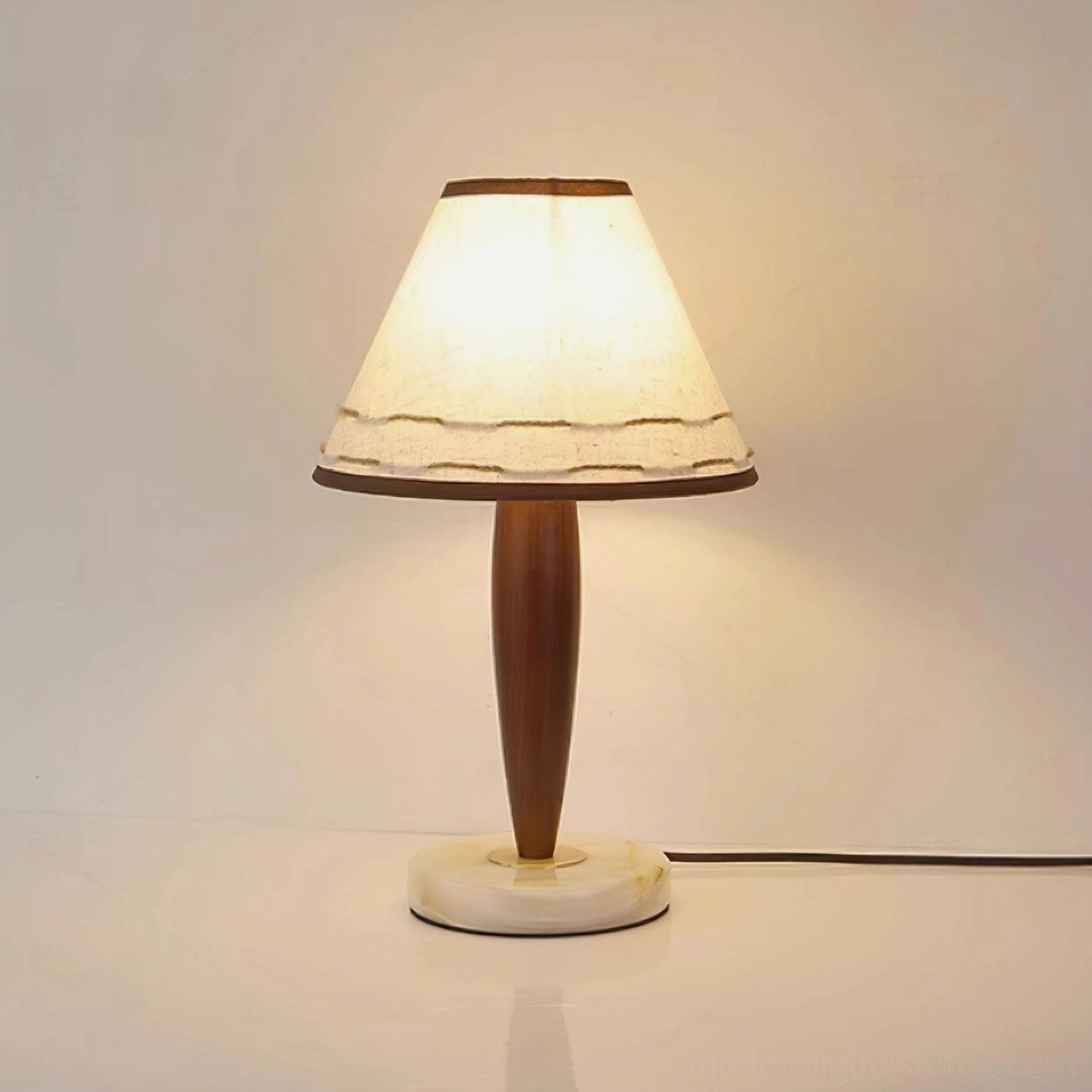 Handcrafted paper shade of terracotta table lamp - detailed stitching and soft light diffusion