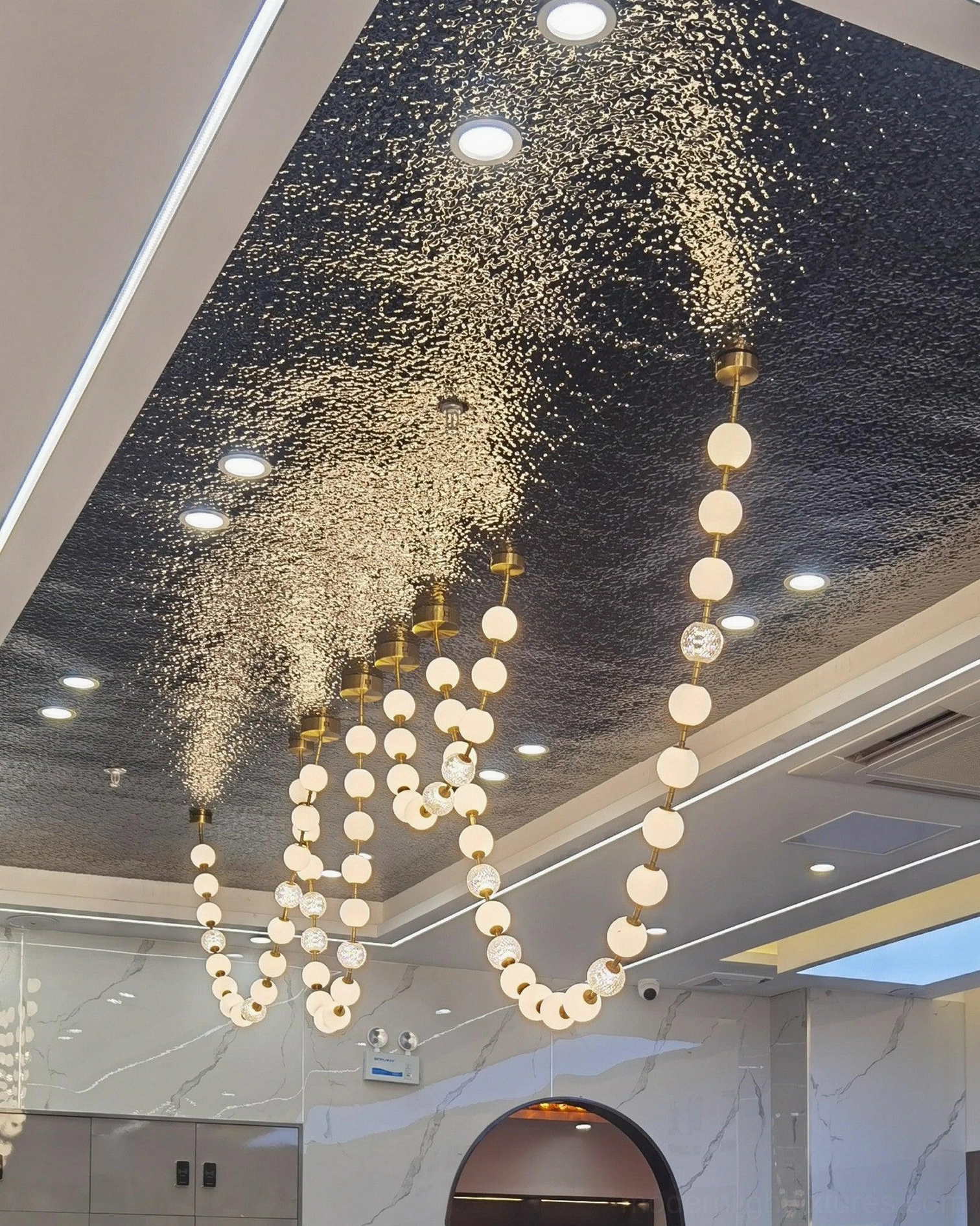 Luxury pearl string light fixture with brass hardware and hand-crafted acrylic sphere construction