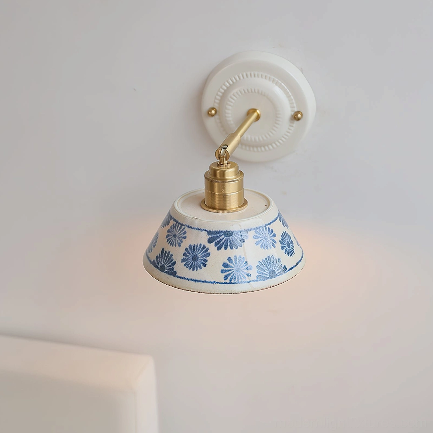 Handcrafted porcelain wall sconce creating directional ambient light in interior space
