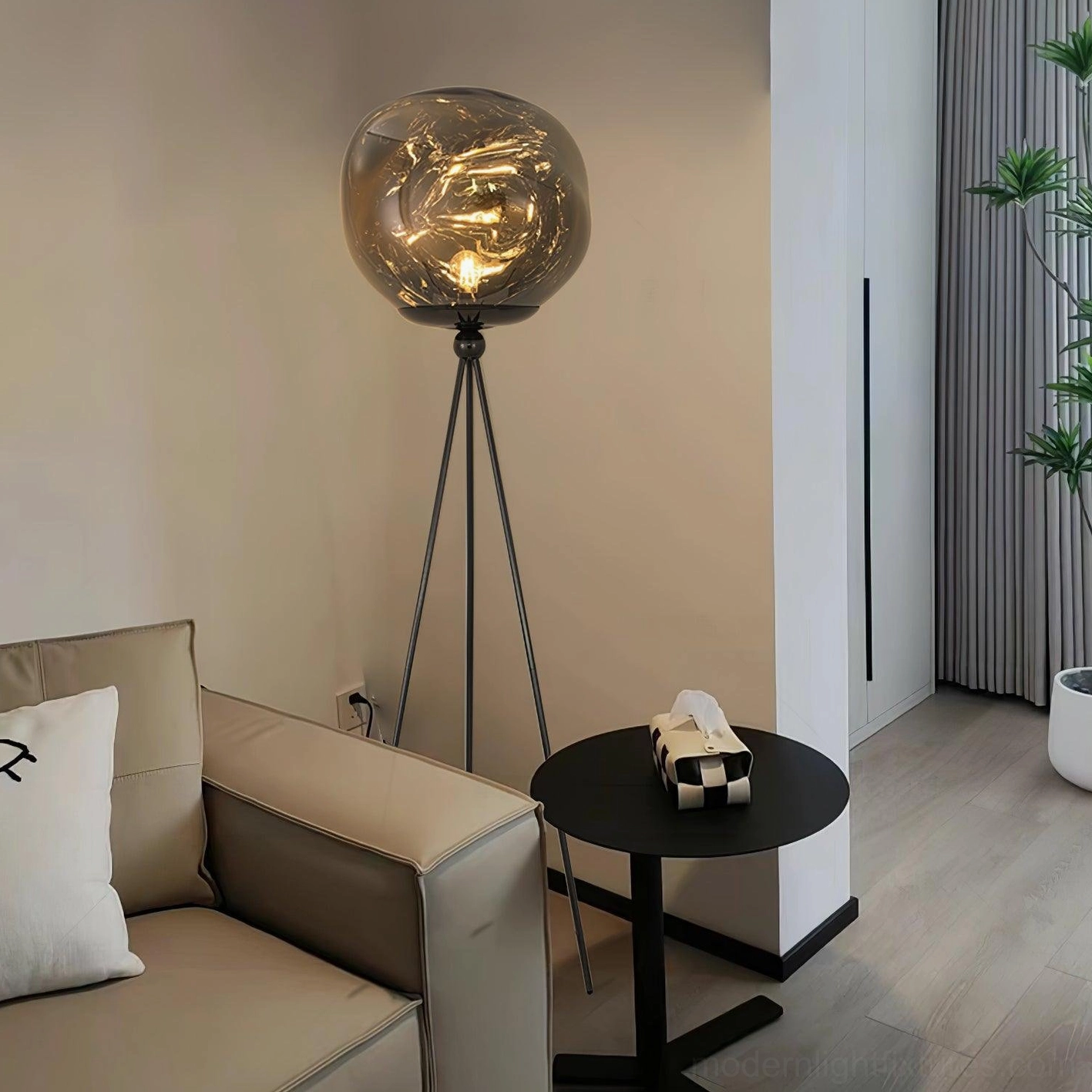 Modern artistic tripod floor lamp with handcrafted molten glass shade and premium metal frame finish