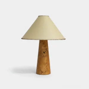 Handcrafted wood table lamp with beige fabric shade featuring visible whip-stitch detailing on white background