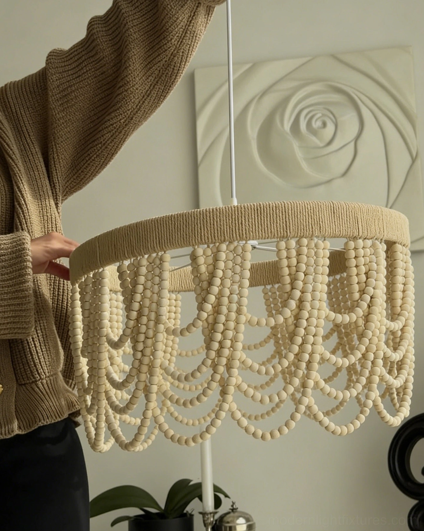 Woven drum pendant light with cascading wooden bead fringe, artisanal handcrafted lighting fixture with natural materials