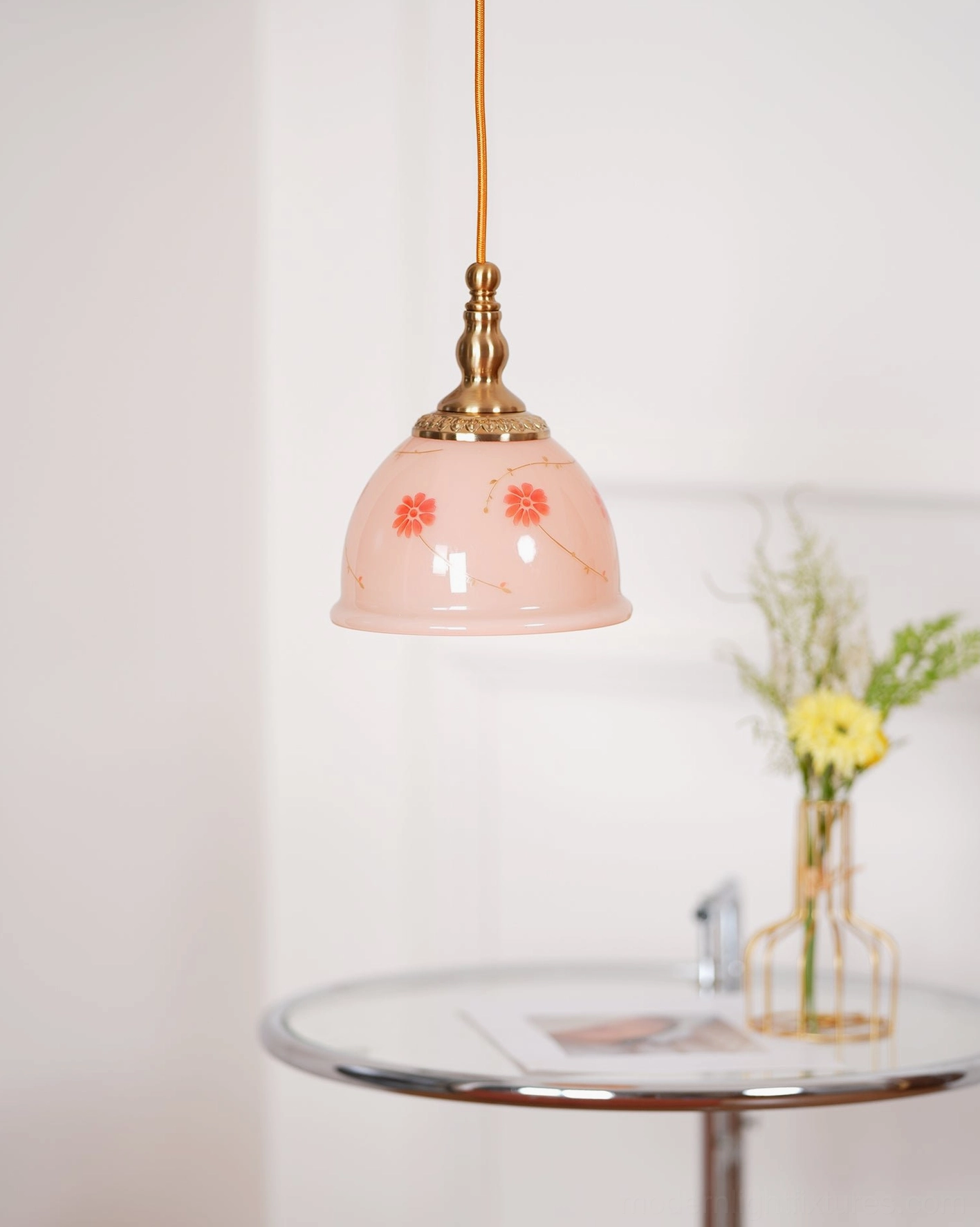 Handmade ceramic floral pendant lamp with brass fixtures displaying delicate red flowers on pink background