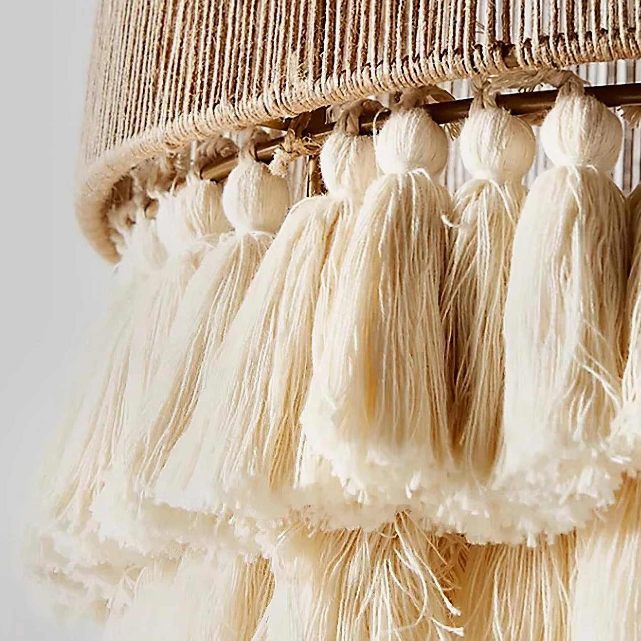 Handwoven boho pendant light suspended in modern minimalist bedroom space