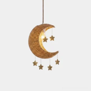 Handwoven rattan crescent moon pendant light with hanging gold metal stars on white background - front studio view