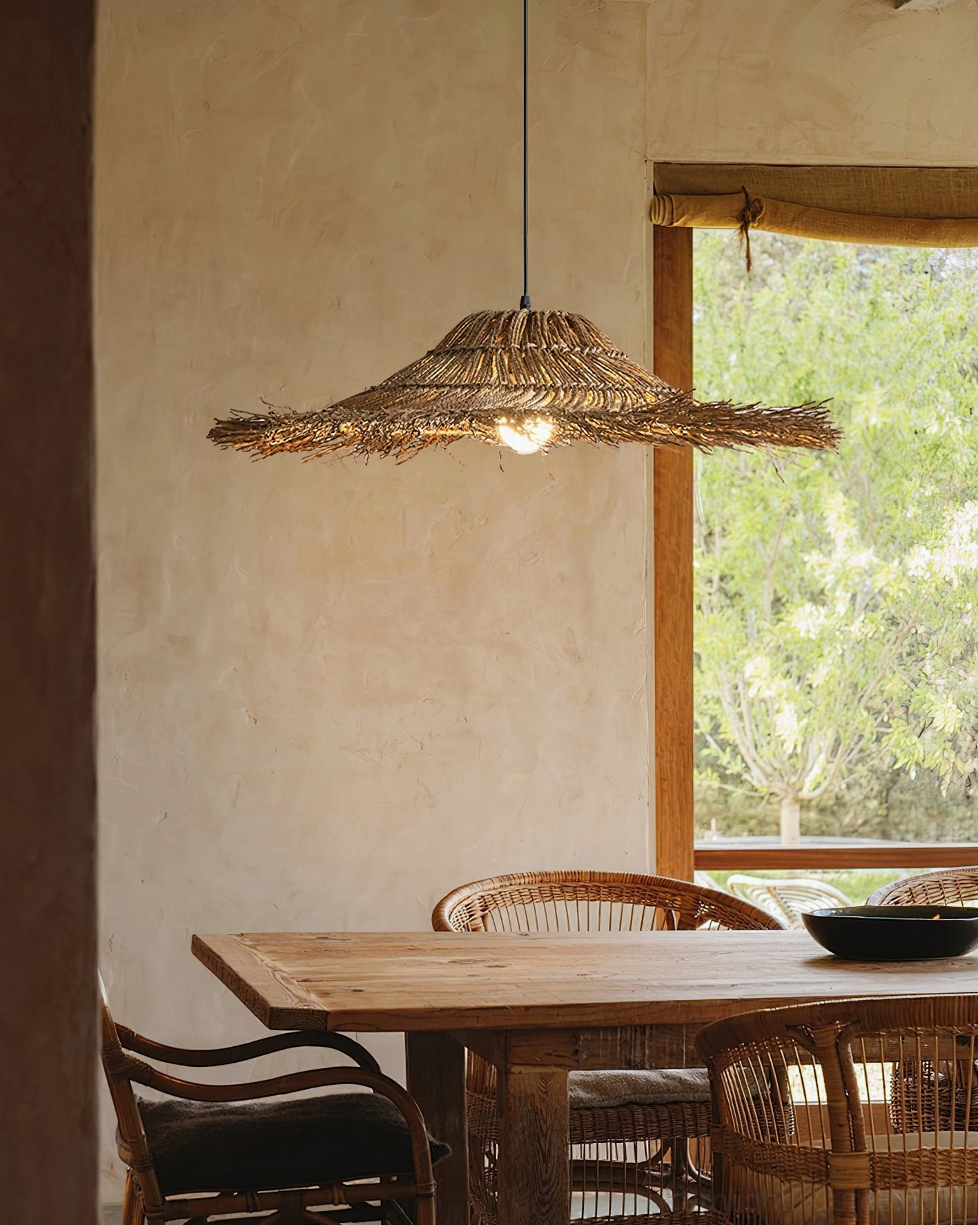 Handwoven natural rattan pendant light showcasing artisanal craftsmanship details, woven fibers and organic irregular silhouette