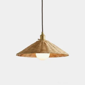Studio shot of handwoven rattan pendant light with gold hardware and white globe bulb, bohemian style conical shade
