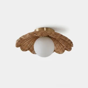 Handwoven dark rattan scallop flush mount ceiling light with opal glass globe and antique brass canopy - front studio view