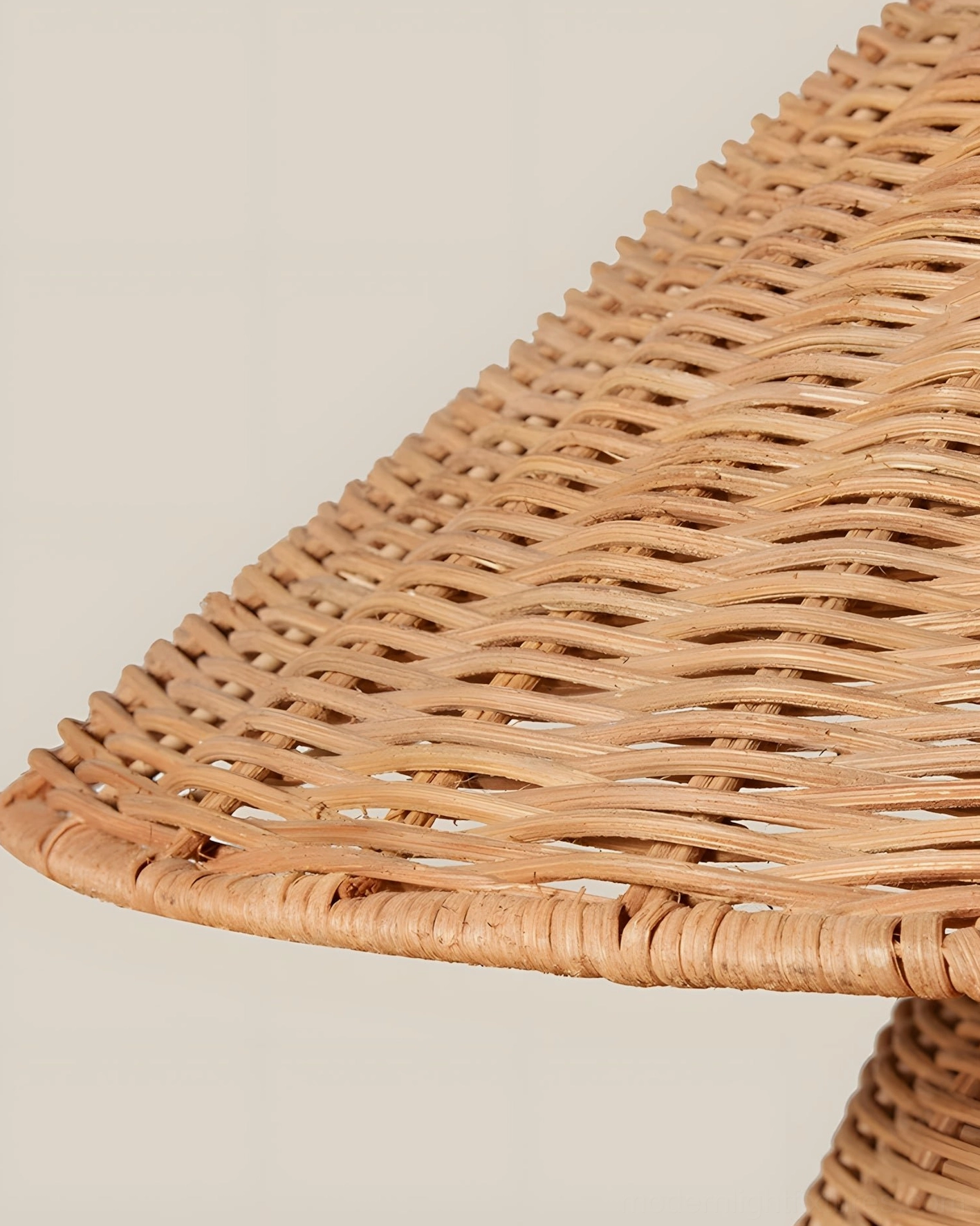 Handwoven rattan table lamp full frontal view, flat studio background emphasizing organic weave pattern and natural warm coloring