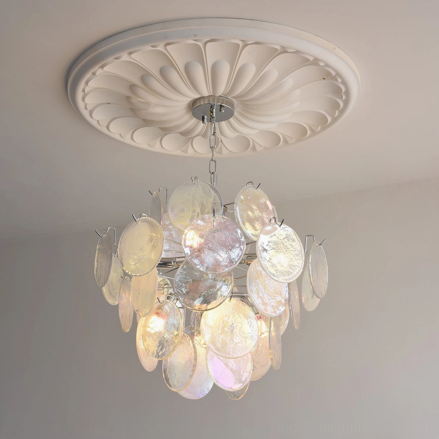 Hanging chain detail of iridescent glass disc chandelier showing adjustable suspension system