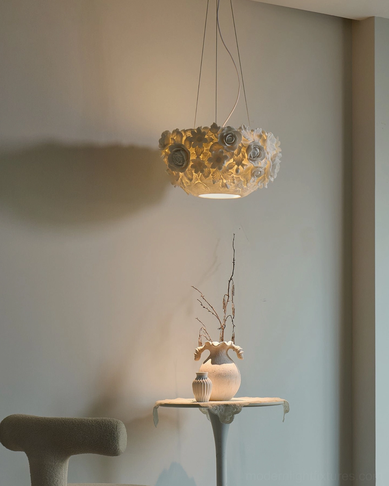 Hanging ceramic flower pendant light with warm illumination, side view showing sculptural shade against minimalist interior corner
