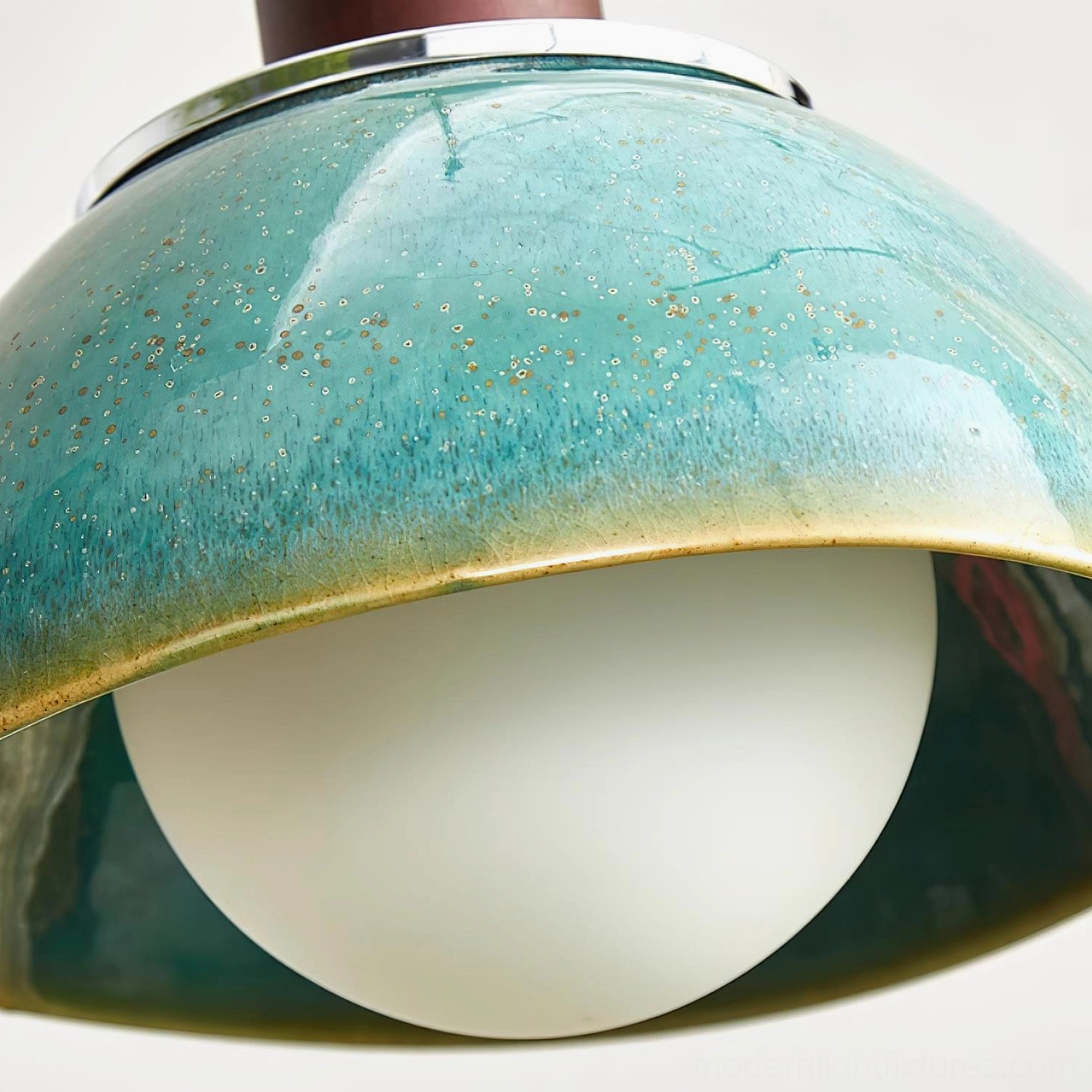 Extreme close-up detail of Harley pendant lamp showing speckled teal glaze texture, brown gradient rim, and frosted glass bulb