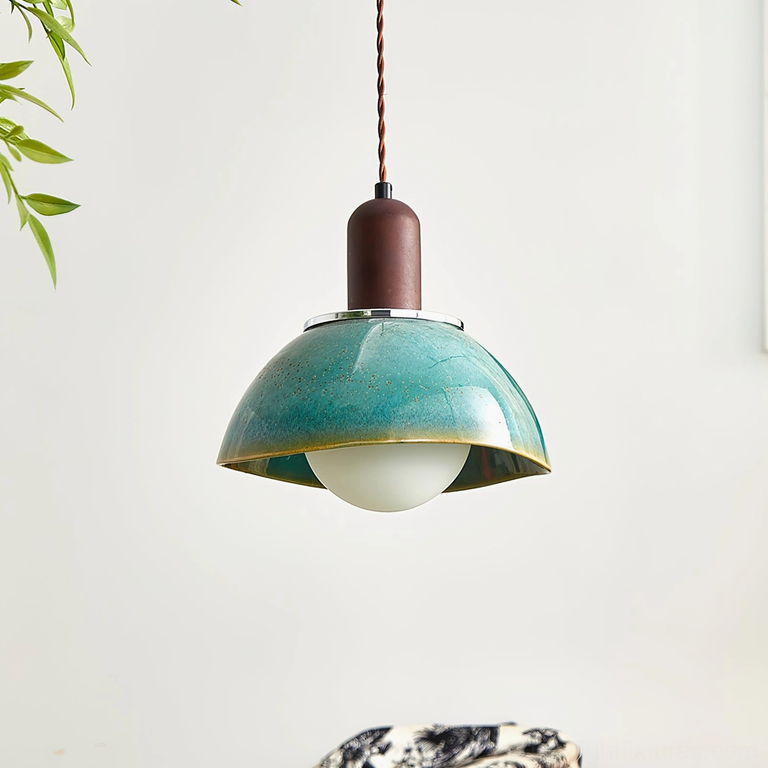 Teal glazed ceramic pendant lamp with frosted spherical bulb, low-angle front view showing speckled finish detail