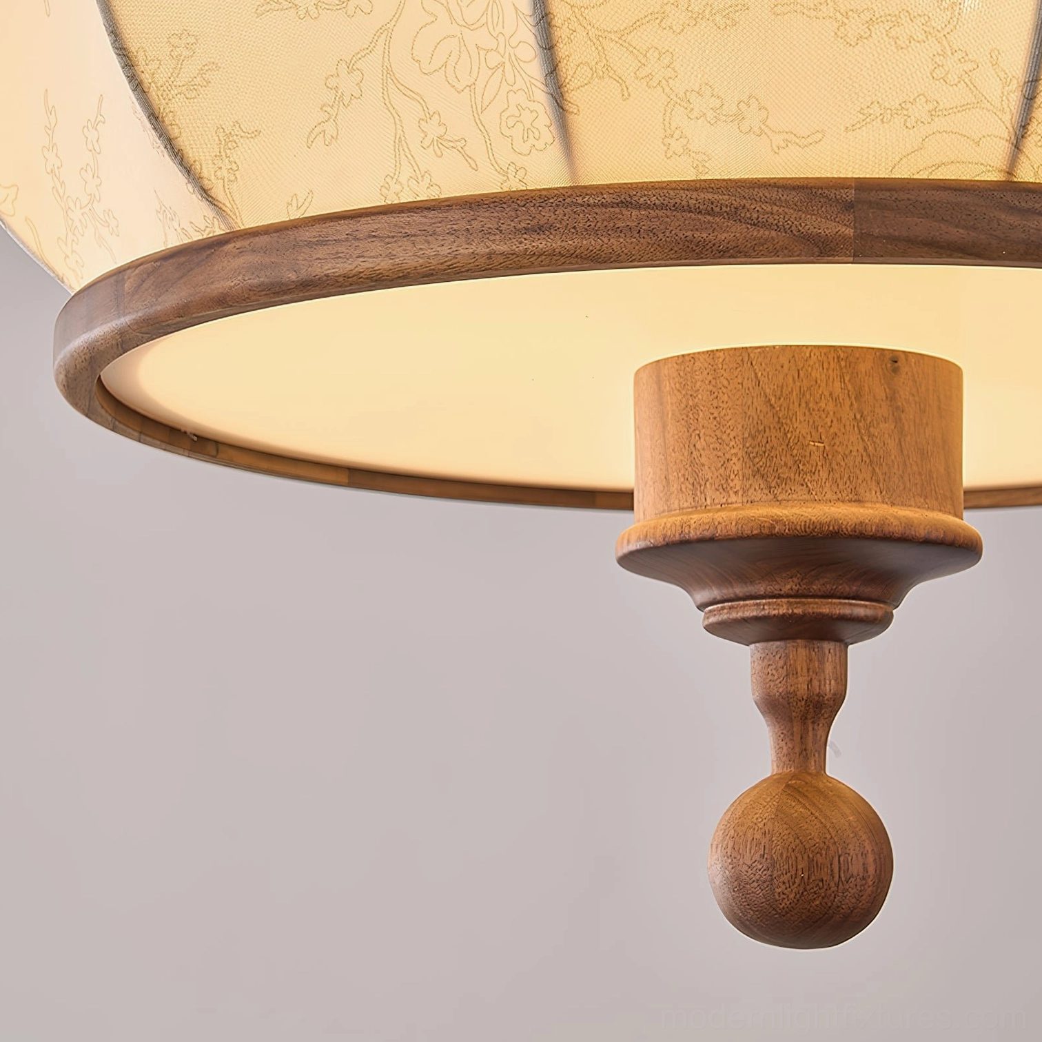 Fabric pendant light fixture with warm beige shade and dark brown wood hardware detail