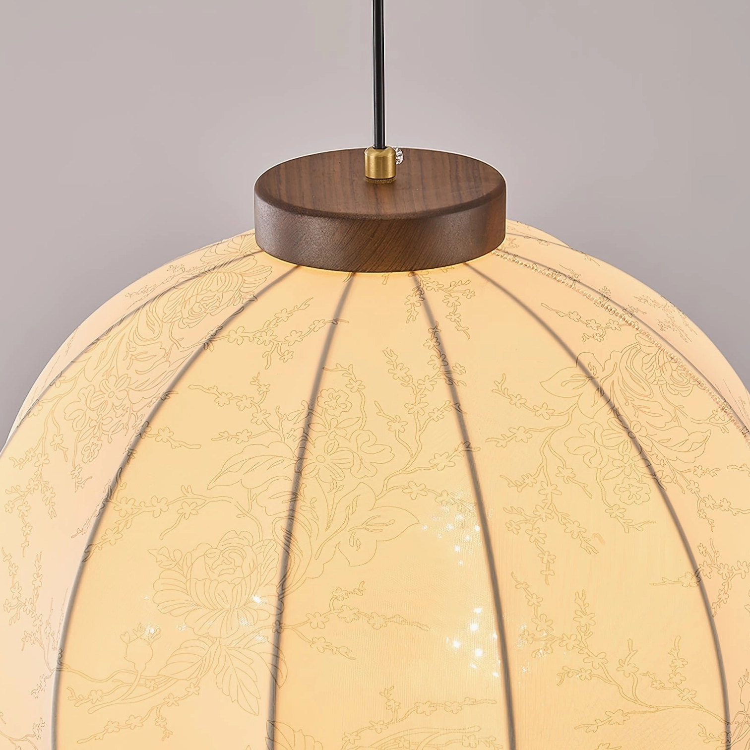 Fabric pendant lamp with intricate pattern detail and walnut wood frame construction