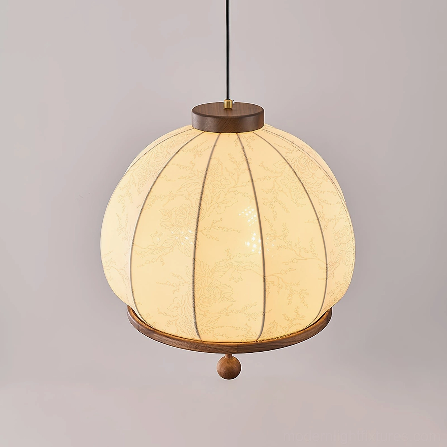 Pendant light with delicate fabric shade and natural wood trim creating soft ambient lighting