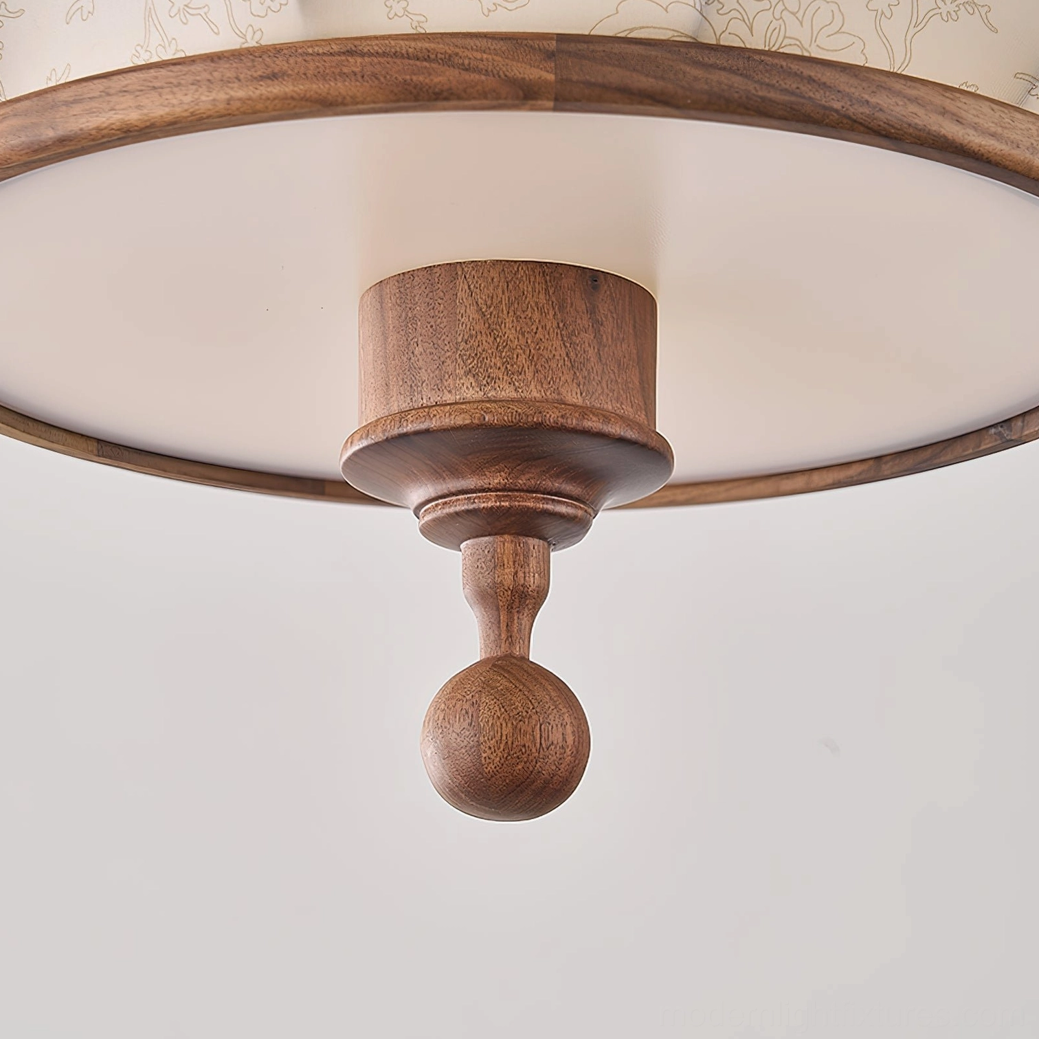 Close-up of fabric pendant lamp shade with embossed floral design and wood trim finish
