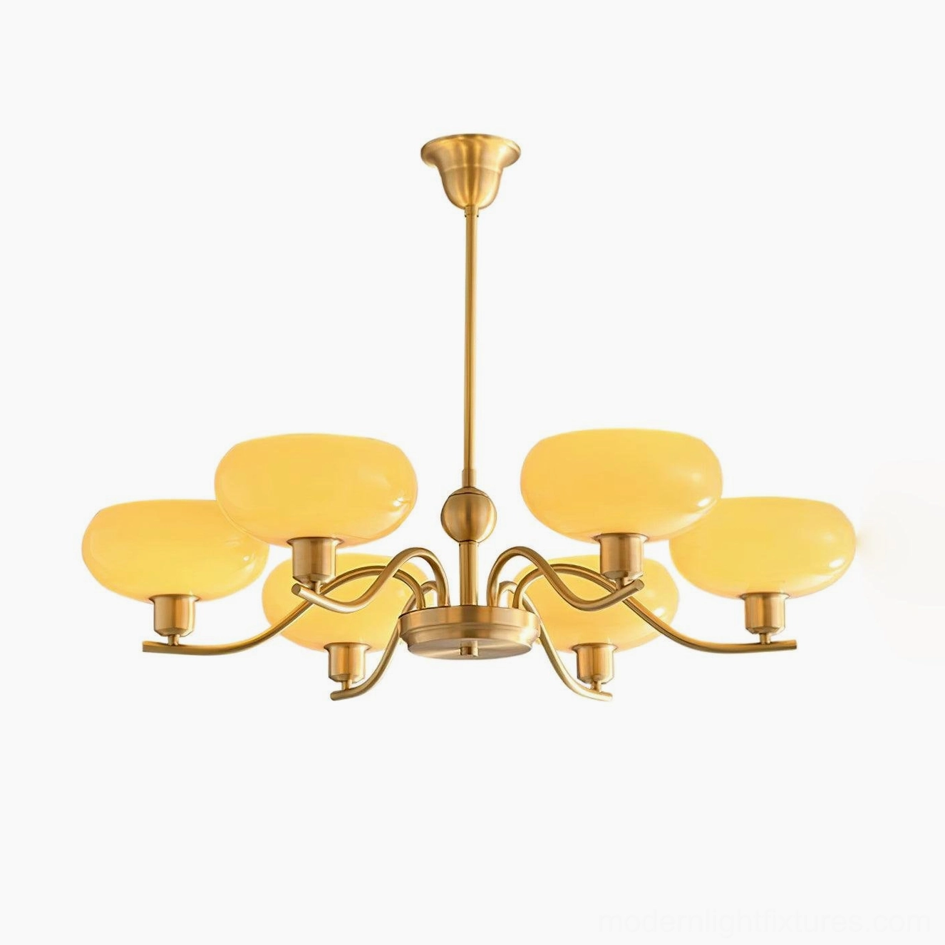 Havana multi-head chandelier mounted above dining table with warm brass finish and beige shades