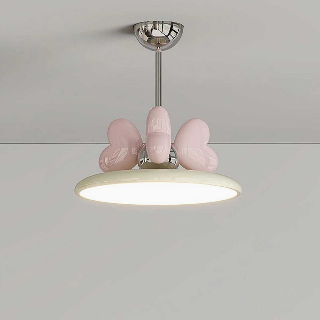 Close-up of heart pendant light with pink heart decoration and chrome hardware