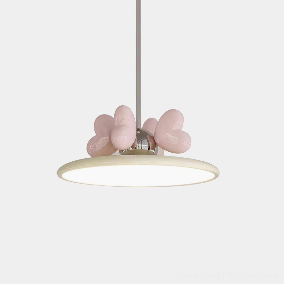 Modern heart pendant light with pink heart decor and creamy acrylic shade on white background