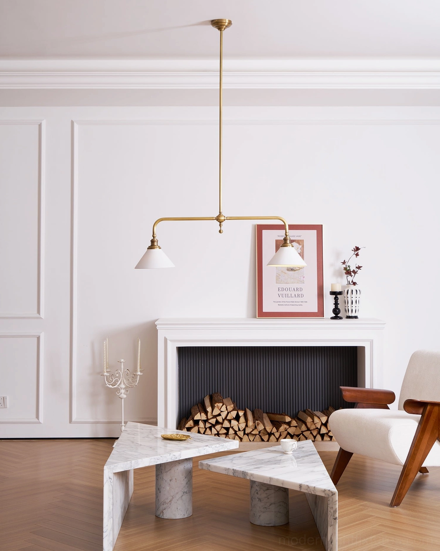 Heirloom-style two-light linear chandelier with ceramic shades showcasing mid-century modern design elements and brass construction