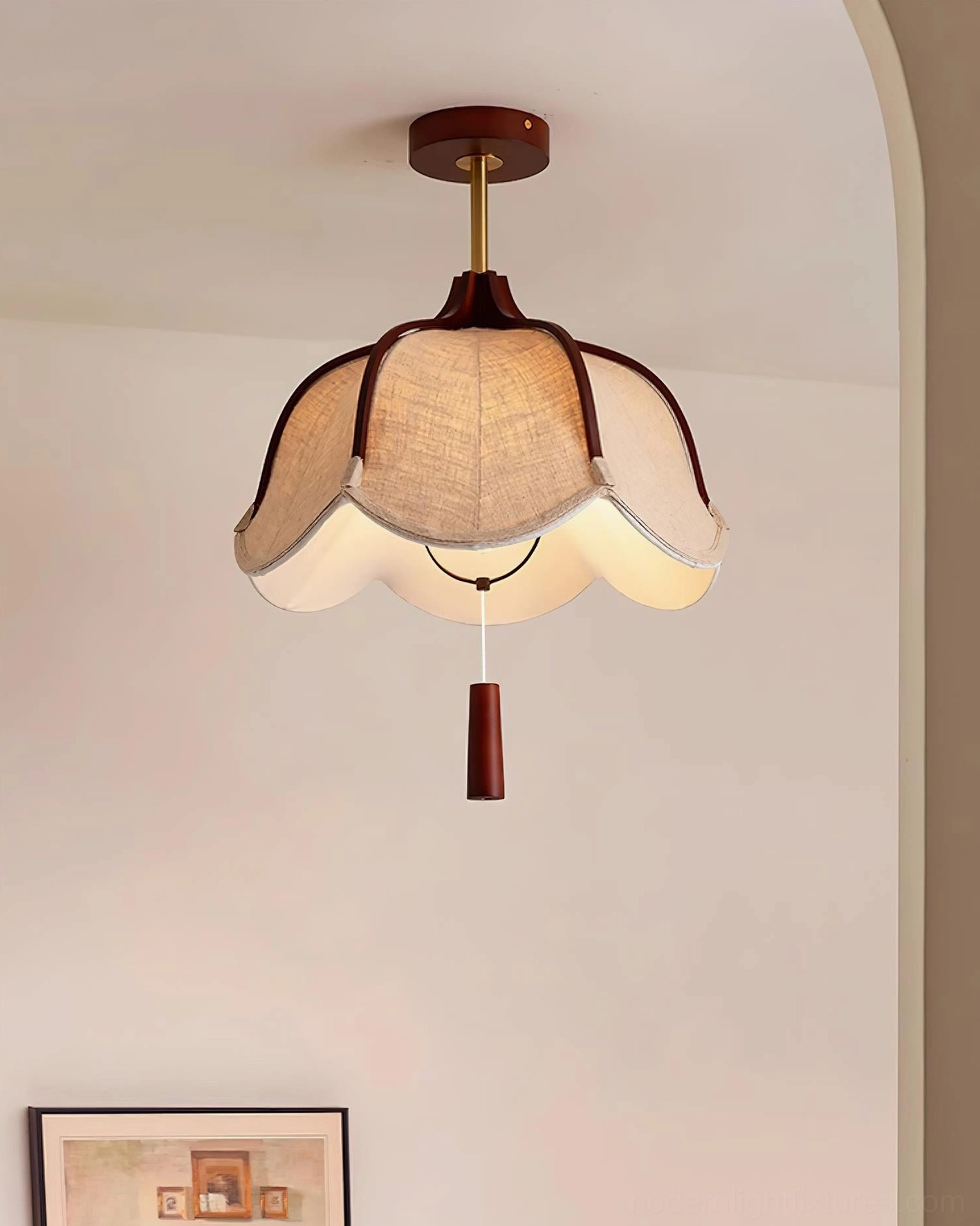Helia pendant light side view in archway setting with wall art, showing brass rod suspension and solid wood construction details