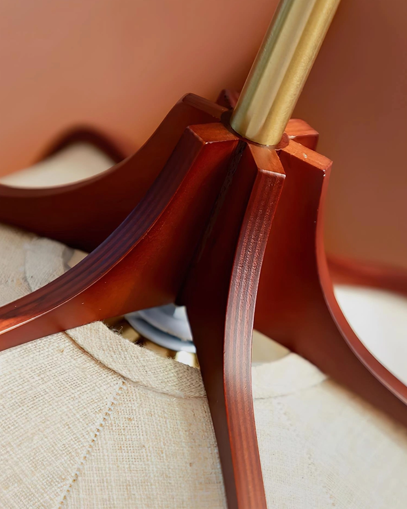 Helia ceiling fixture close-up of solid wood joinery and brass support rod connection detail