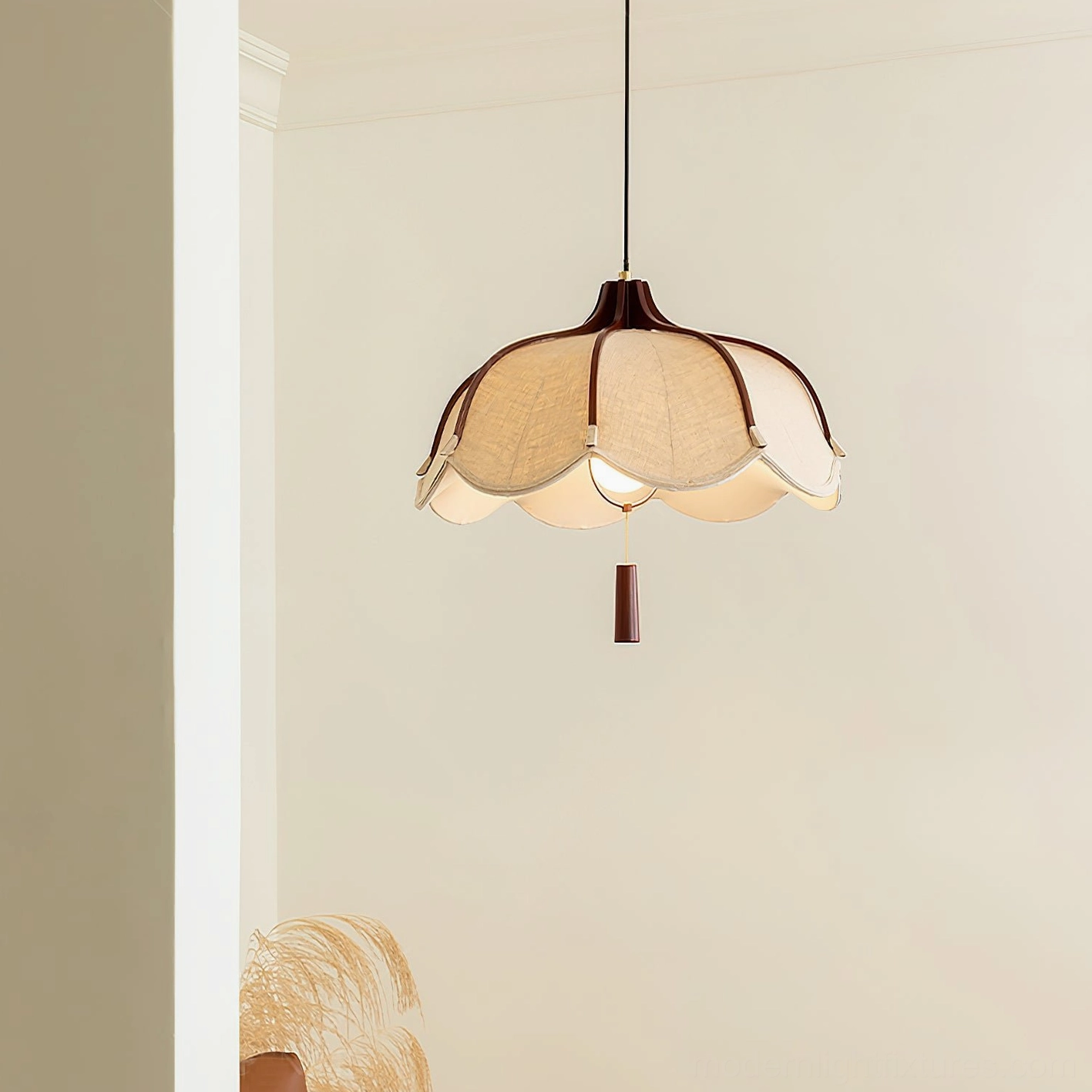 Three-quarter view of Helia fabric pendant lamp with wooden pull decoration, minimalist interior setting