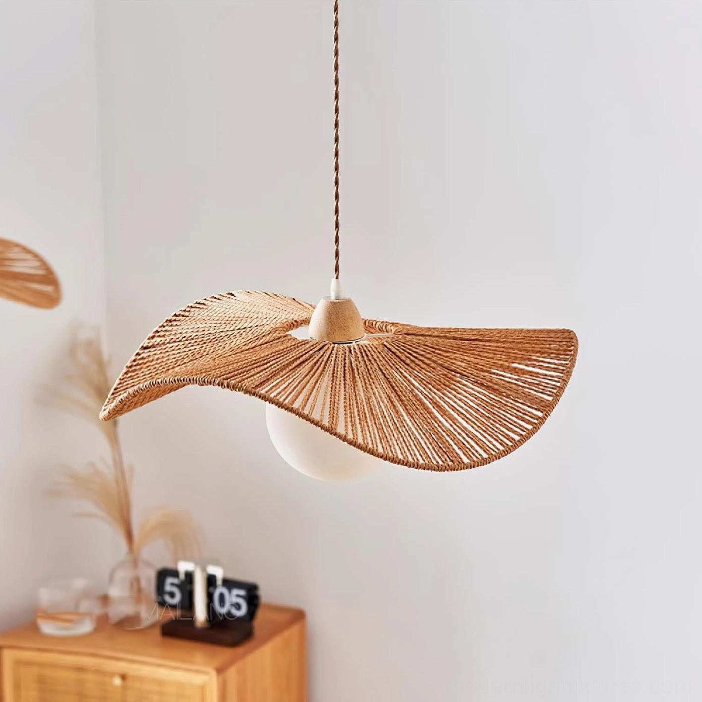 Contemporary hemp rope pendant light in bedroom setting with wooden cabinet and boho décor