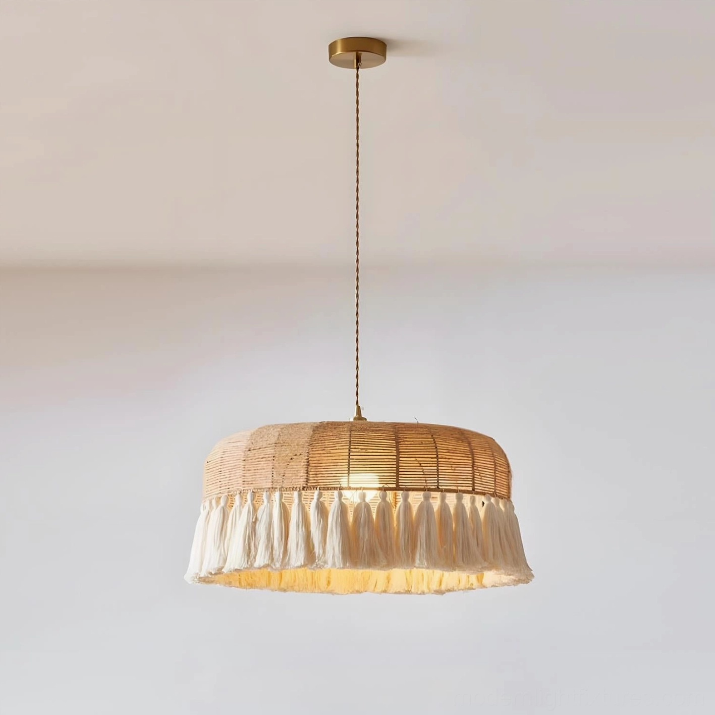 Natural hemp rope pendant light with brass ceiling mount and tassel fringe, low angle front view