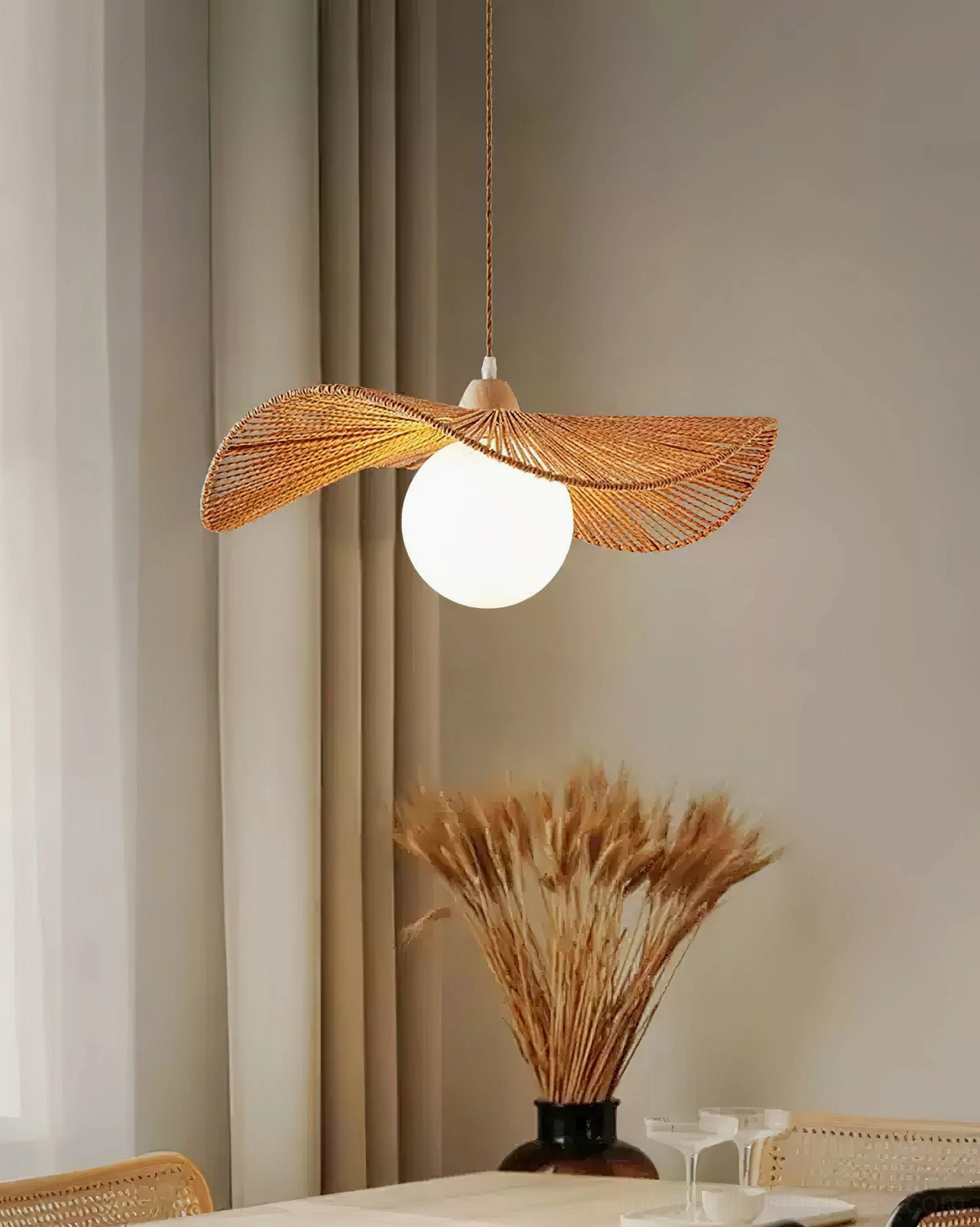 Modern hemp rope pendant light in dining area with dried pampas grass and neutral home décor