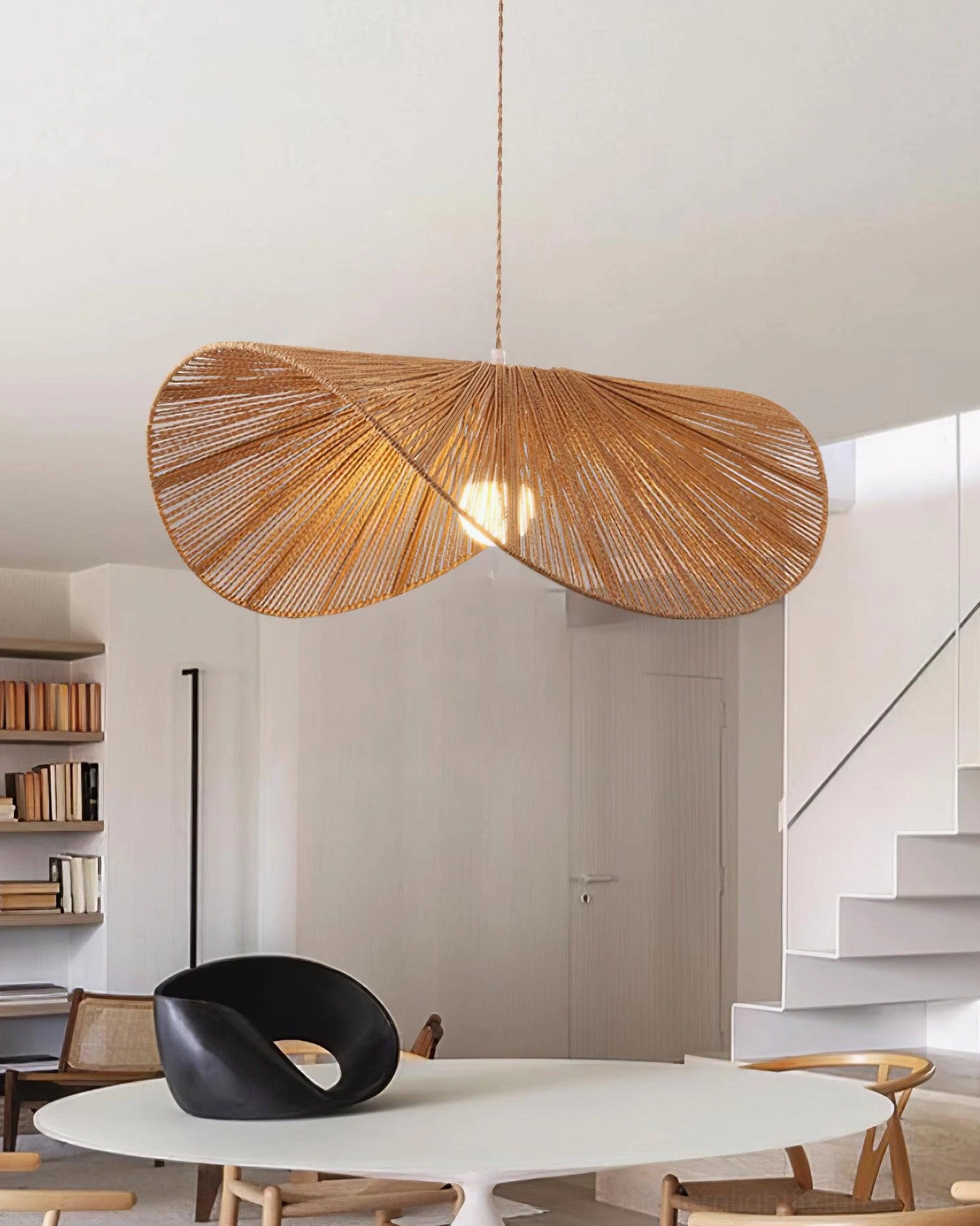 Warm brown woven rope straw hat pendant light creating ambient shadow patterns on ceiling
