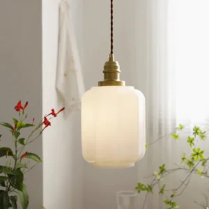 Henry tapered pendant lamp illuminated in home interior with green plant decor, warm ambient lighting