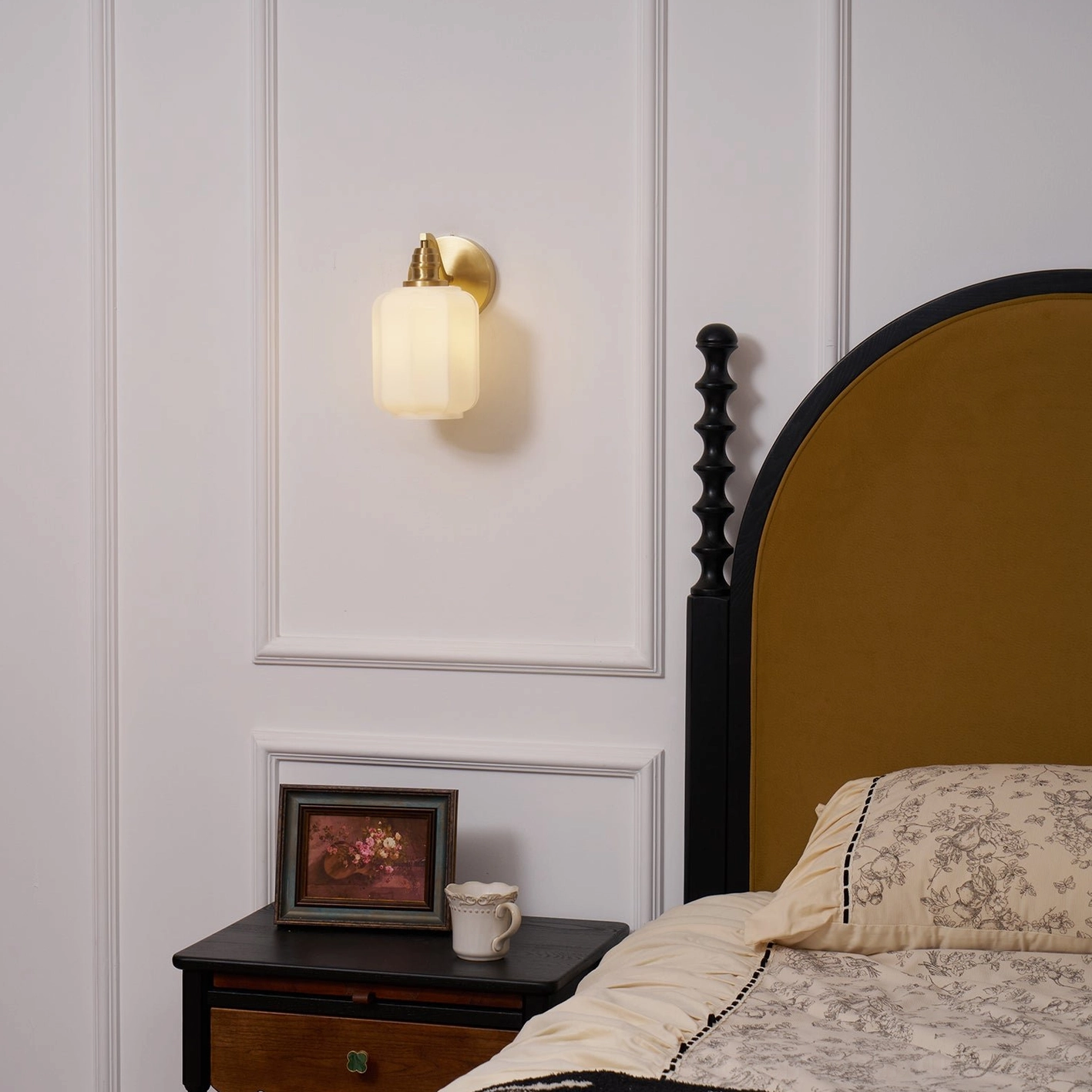 Henry brass wall sconce in eclectic bohemian interior with warm material richness and patina character