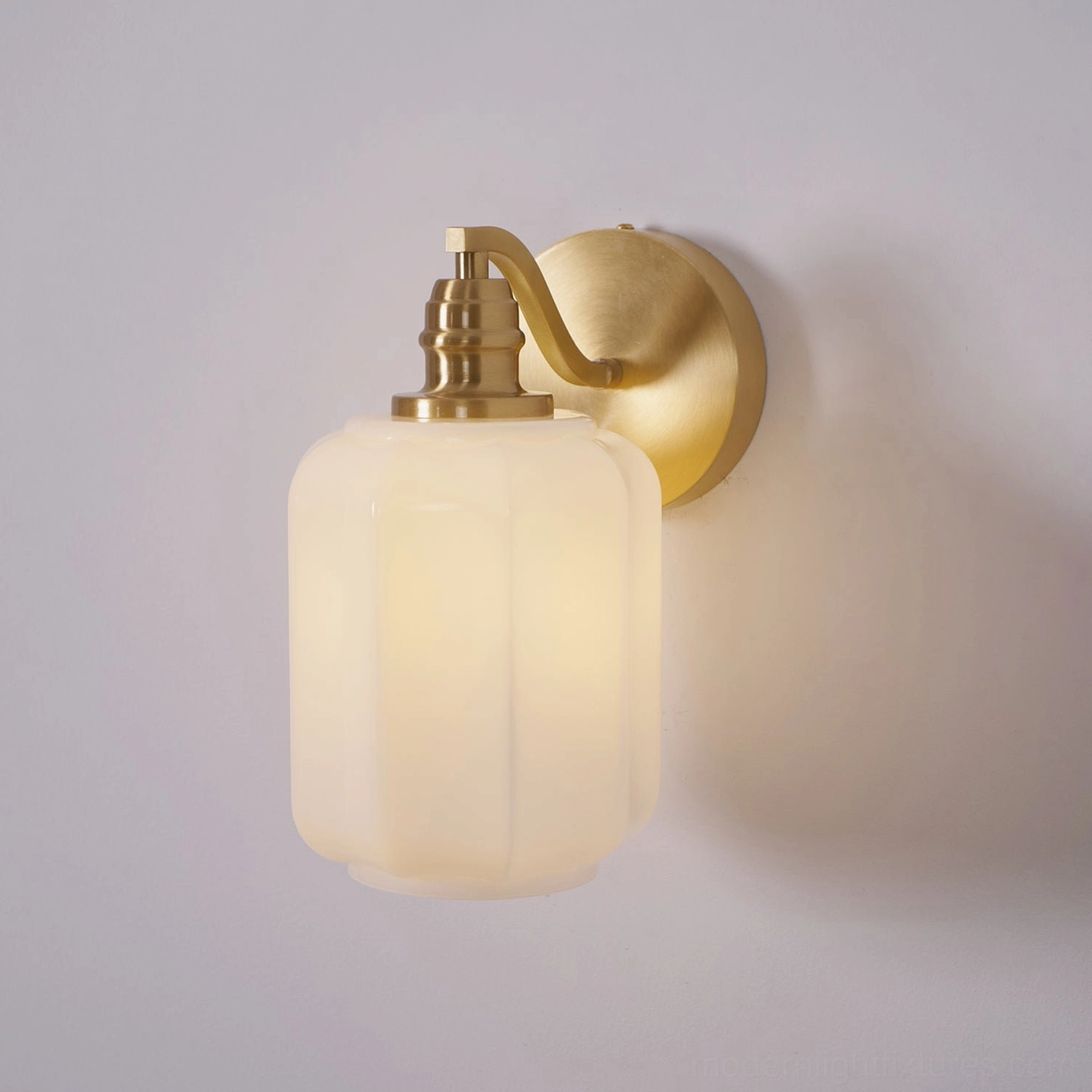 Henry brass wall sconce showing patina development and aging character over extended residential use