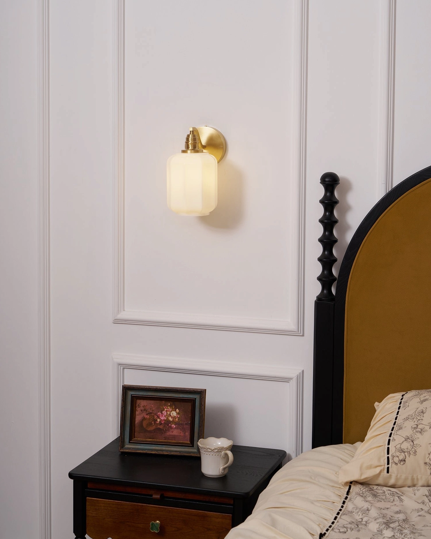 Henry brass wall sconce frosted glass diffuser reducing glare while maintaining directional downward light