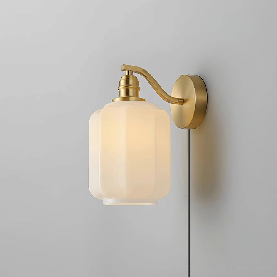 Henry white frosted glass wall sconce with brass metal frame and hardware detail