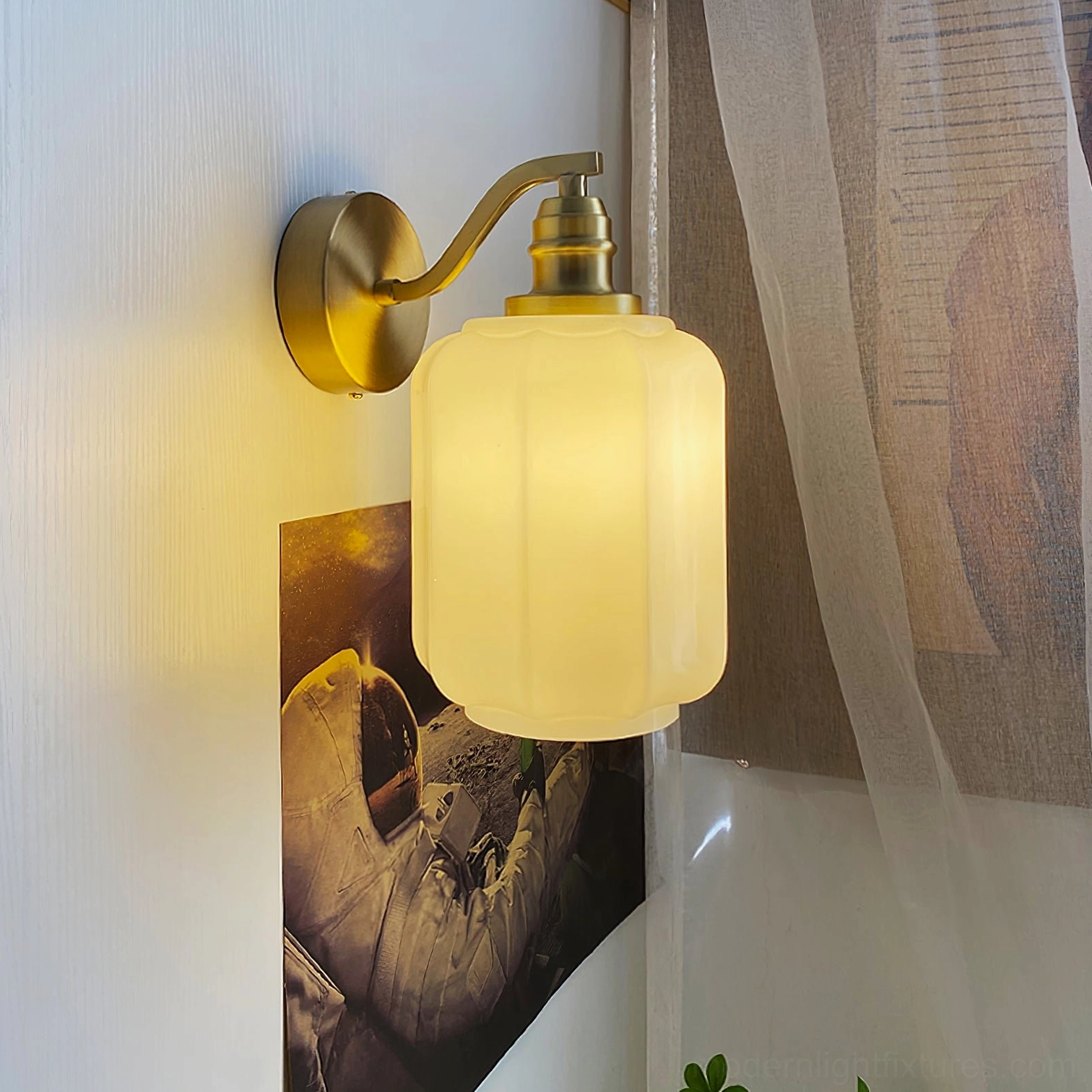 Henry brass wall sconce with warm glowing light creating cozy vintage ambiance in home setting