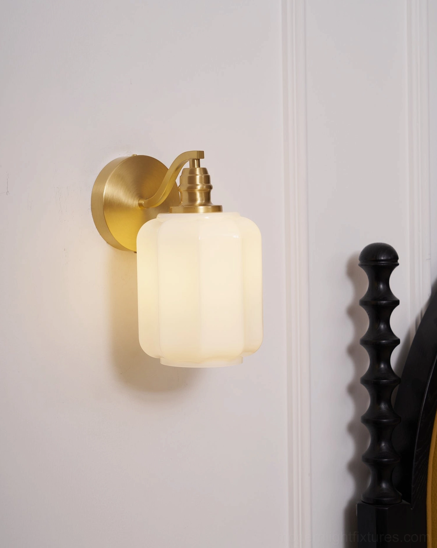 Henry wall sconce showing thoughtful proportions creating visual balance above furniture arrangement