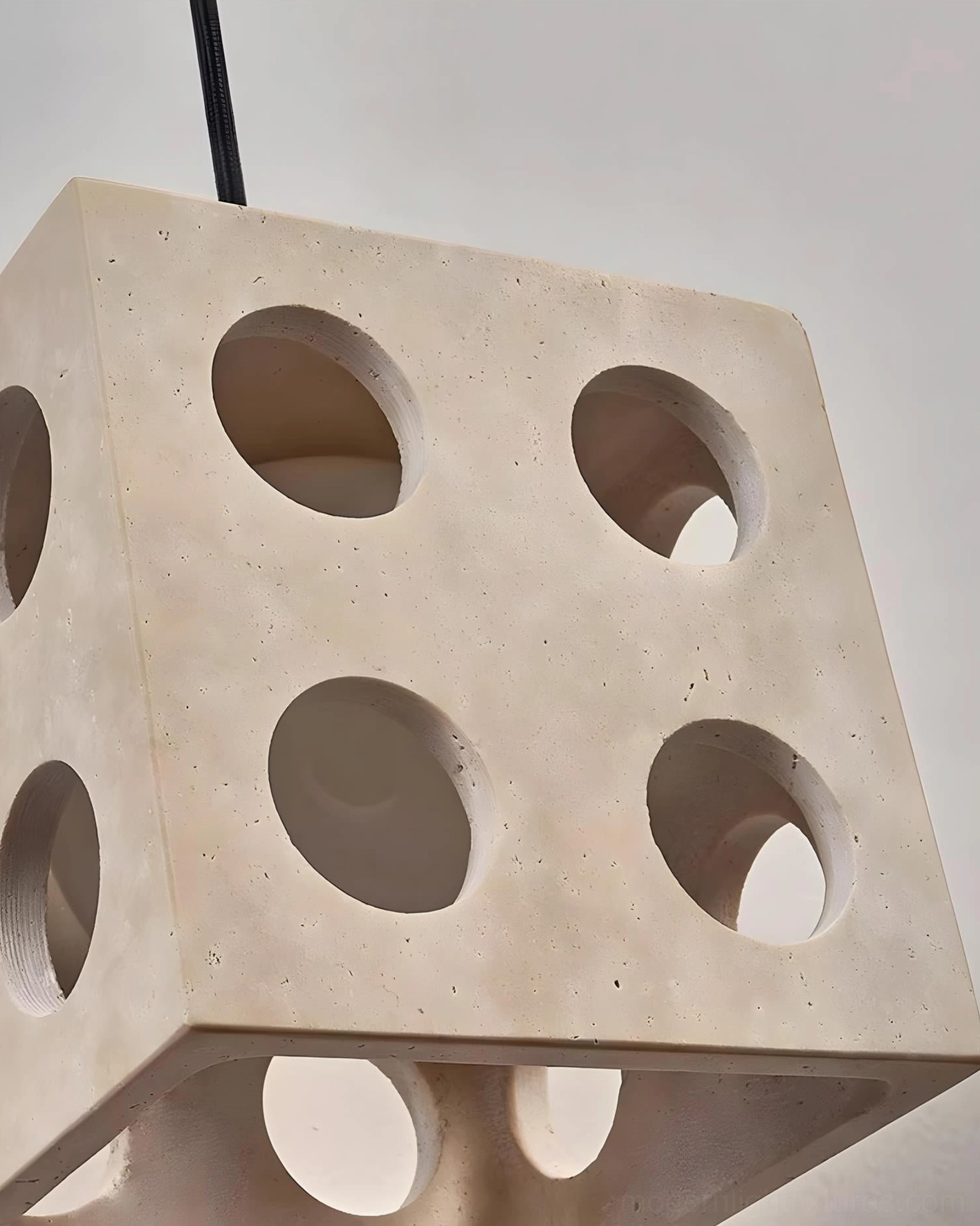 Hexa pendant fixture product shot highlighting sculptural minimalist cube form and natural travertine stone finish