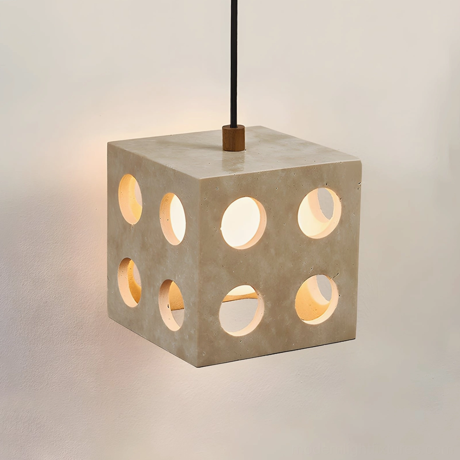 Hexa cube pendant light close-up showing geometric perforation design and warm light diffusion through glass interior