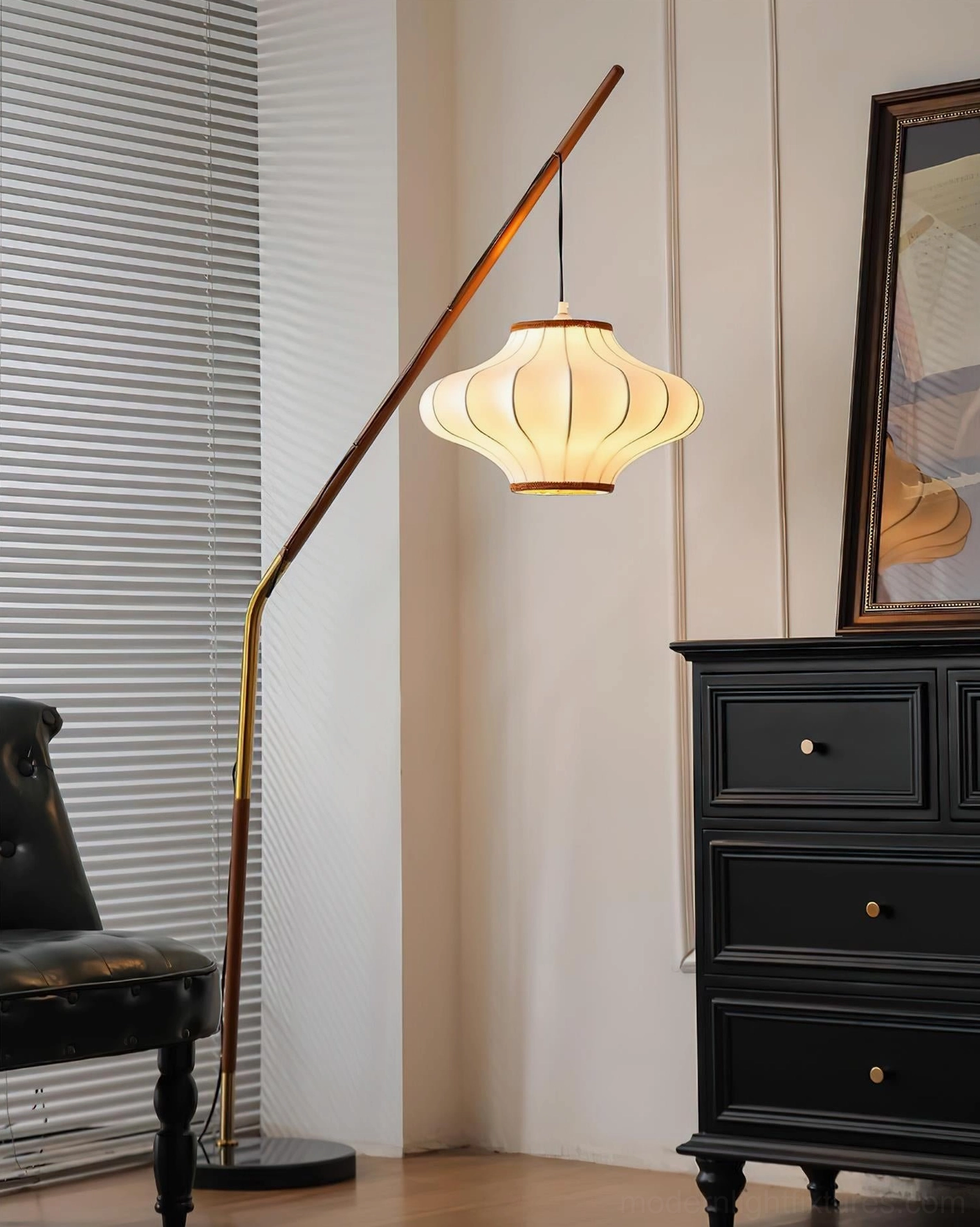Brightly lit arc floor lamp with warm fabric shade and wooden accent pole in vintage living room design